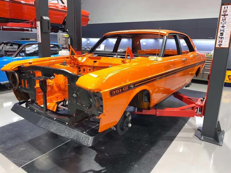 Orange Car Being Lifted — Restore Your Ford Falcon GT in Australia