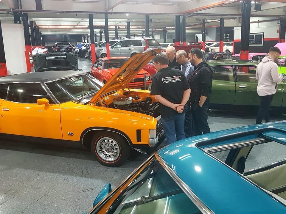 A Group of People Looking at a Car — Restore Your Ford Falcon GT in Australia
