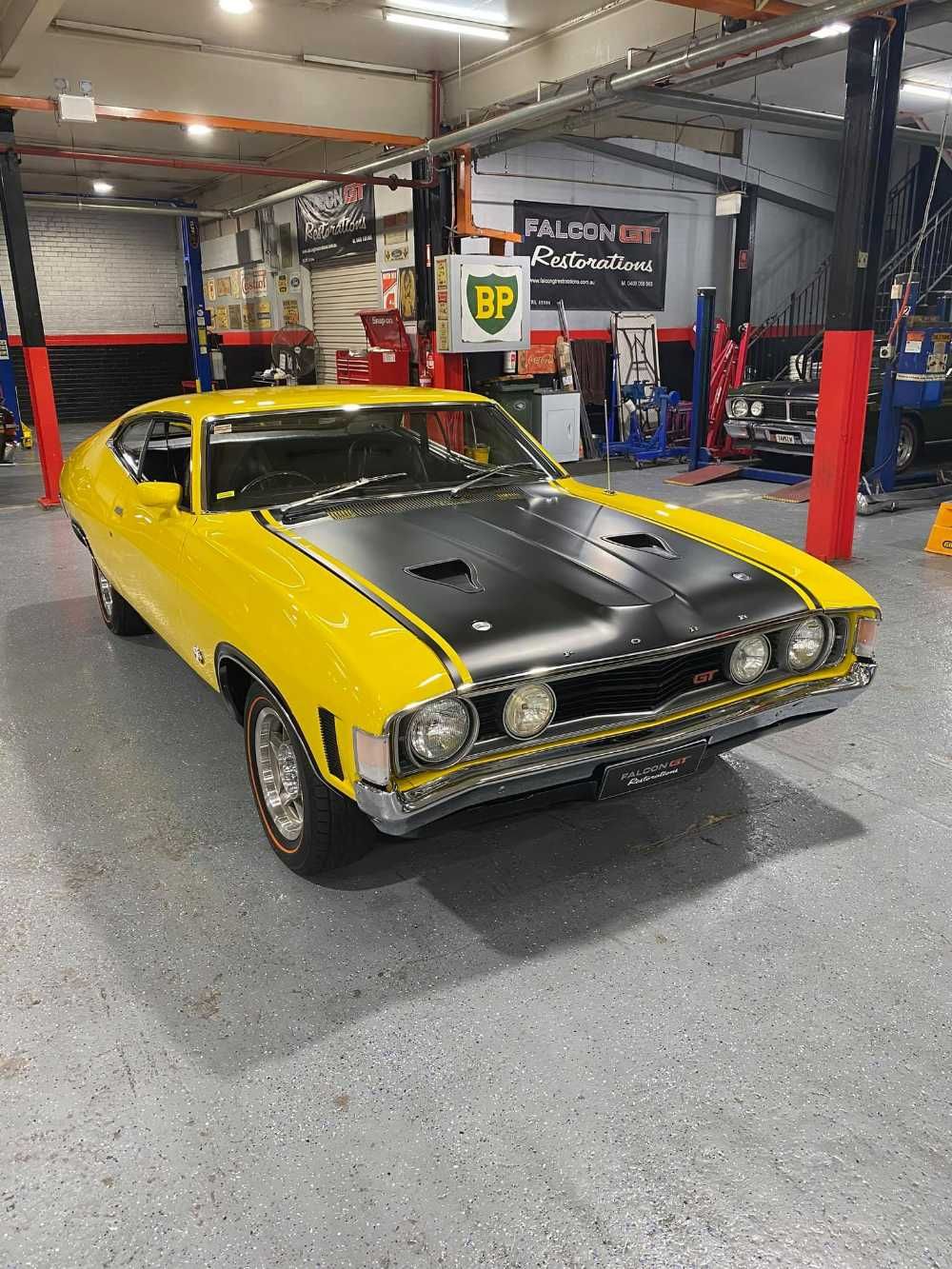 A Garage With a Black and Yellow Car — Restore Your Ford Falcon GT in Australia