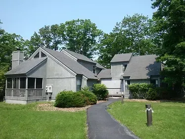 A large house with a driveway leading to it