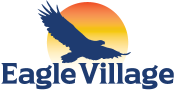 The logo for eagle village shows an eagle flying in front of a sunset.