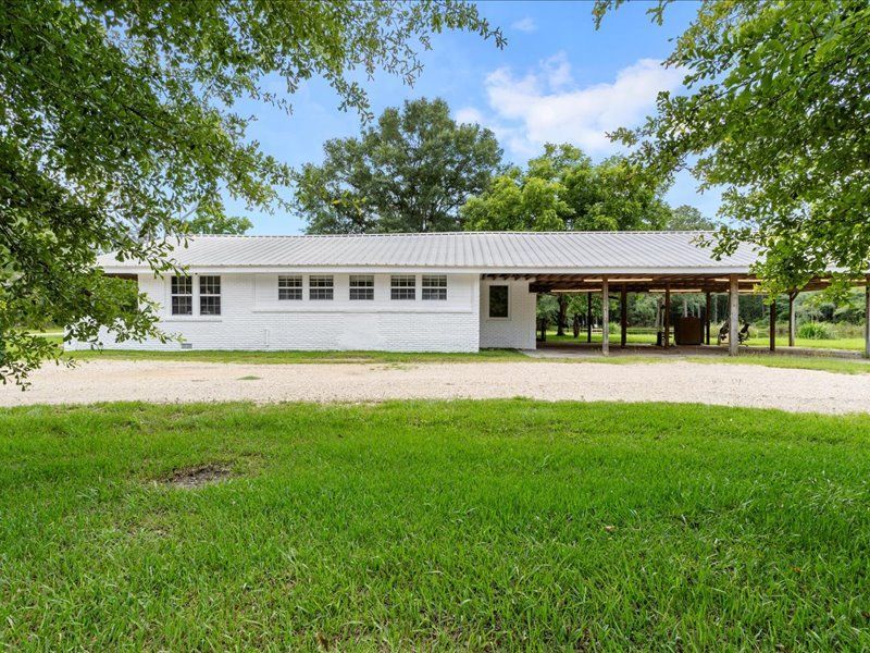 A patio with a lot of furniture and lights at night.