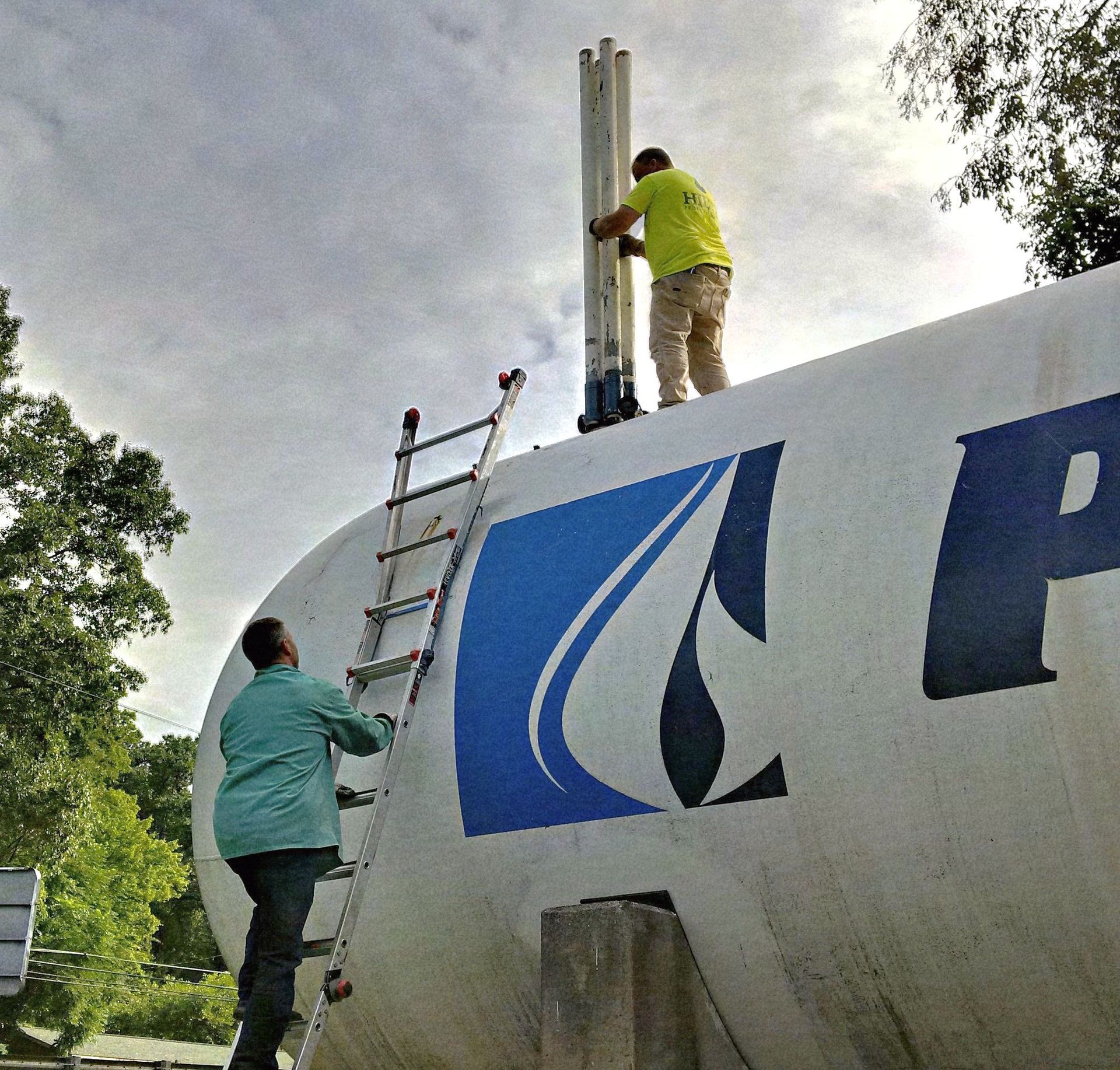 Three pressure gauges are hanging from a pipe on a wall.