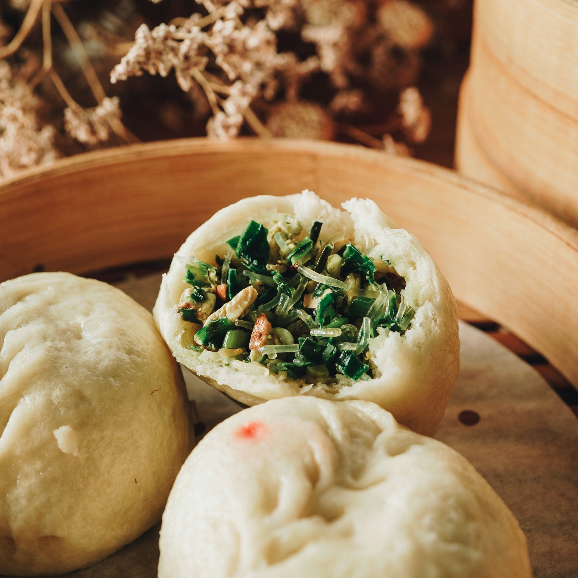 A bunch of dumplings with green vegetables in them