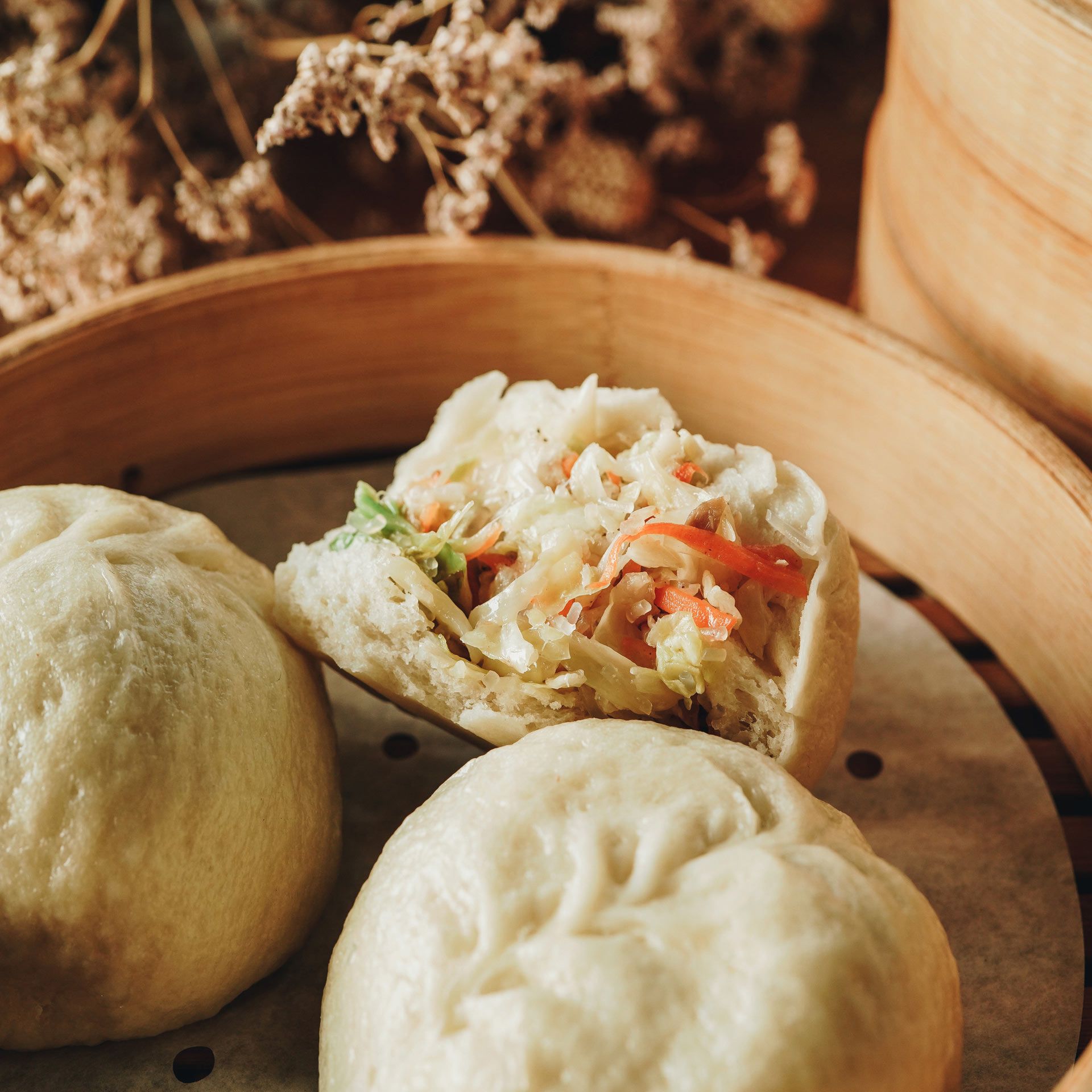A close up of a bun with vegetables in it