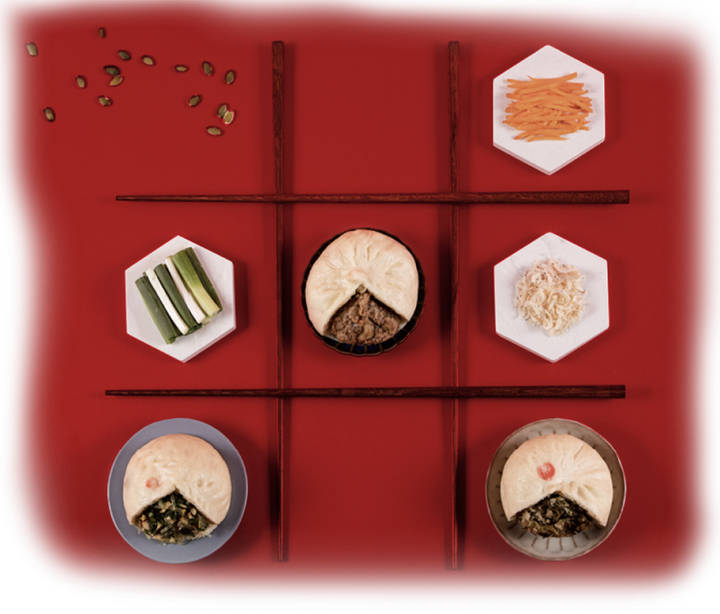 A tic tac toe game with plates of food and chopsticks