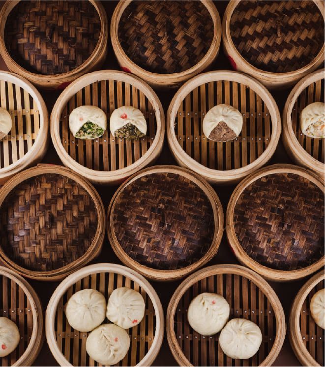 A bunch of bamboo baskets filled with different types of food