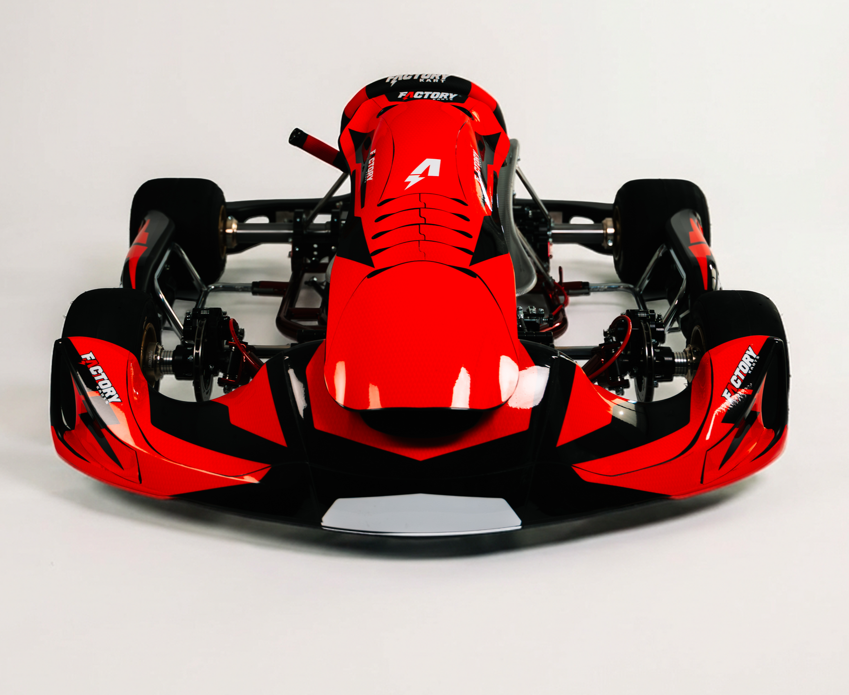 Red Formula-style race car viewed from the front on a white background