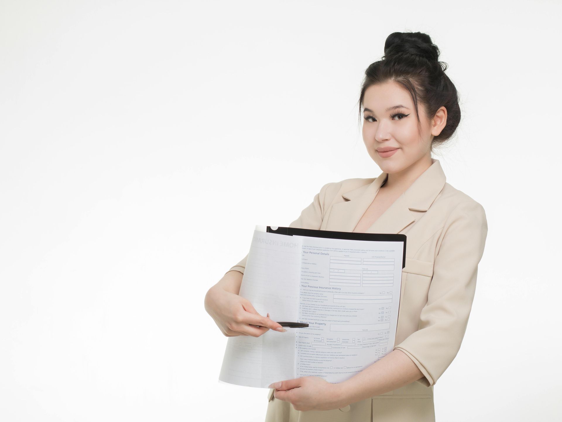 A woman in a suit is holding a clipboard and a piece of paper.