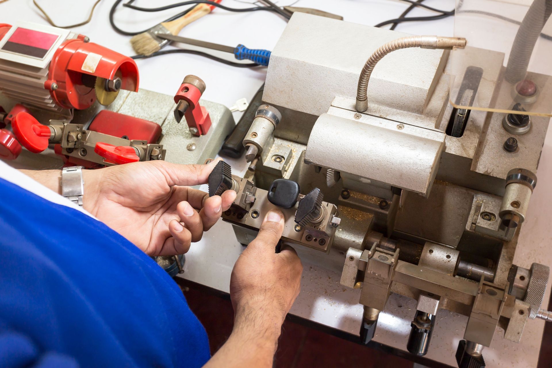 A Person is Using a Machine to Make Keys