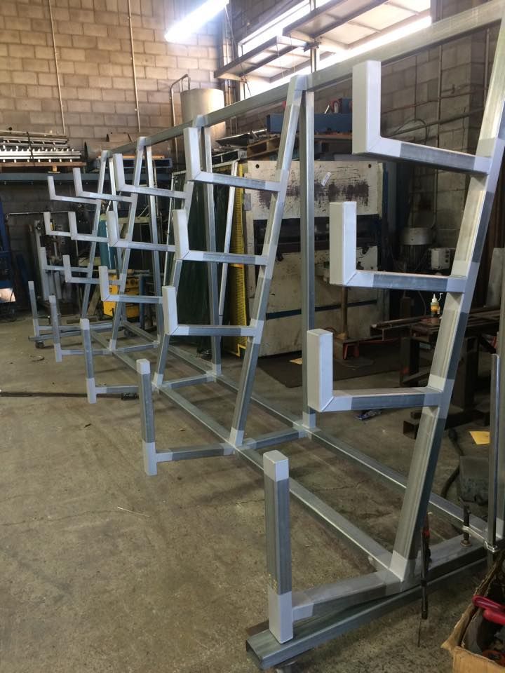 A metal structure is being built in a factory.