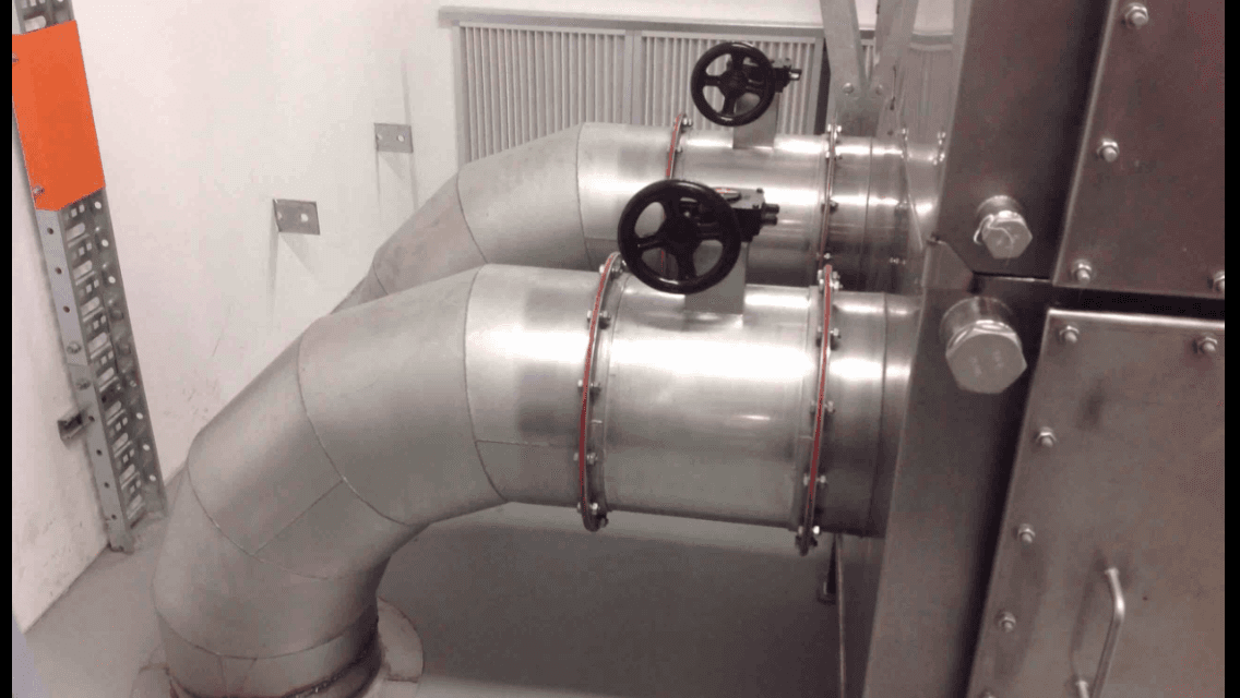 A room with a lot of pipes and valves on them