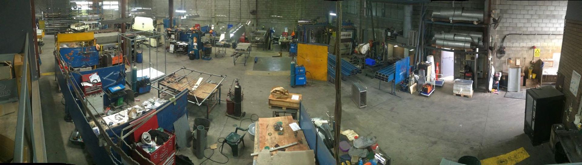 A large warehouse filled with lots of machinery and people.