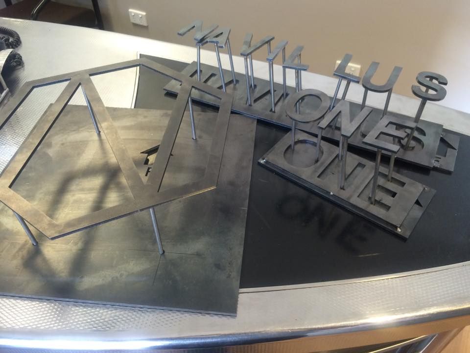 A metal sign that says honest one is on a table