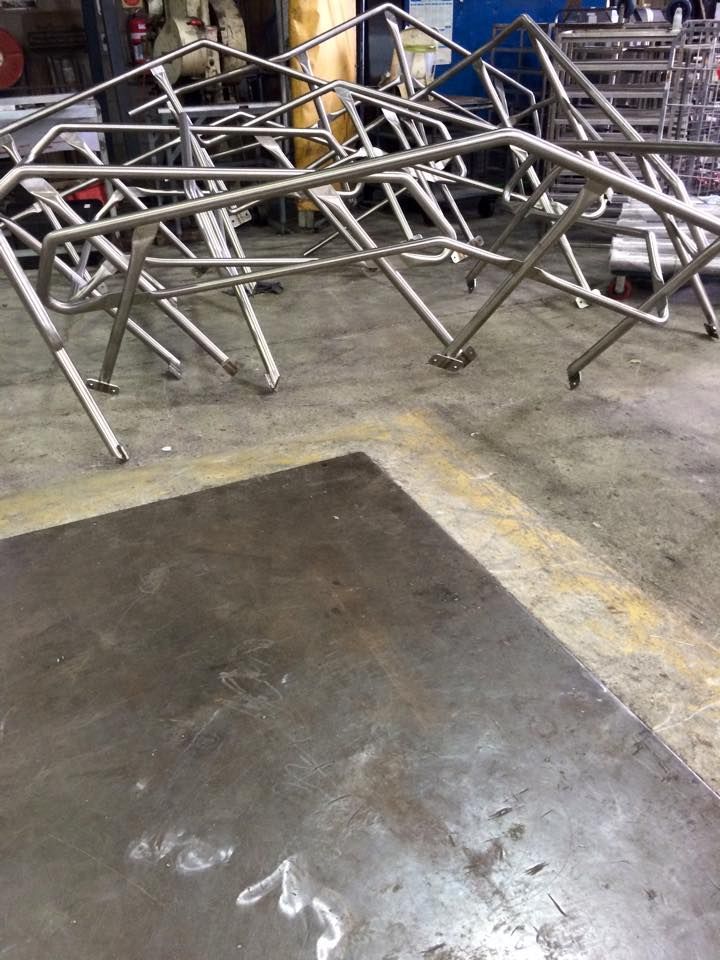A stainless steel structure is sitting on top of a concrete floor.