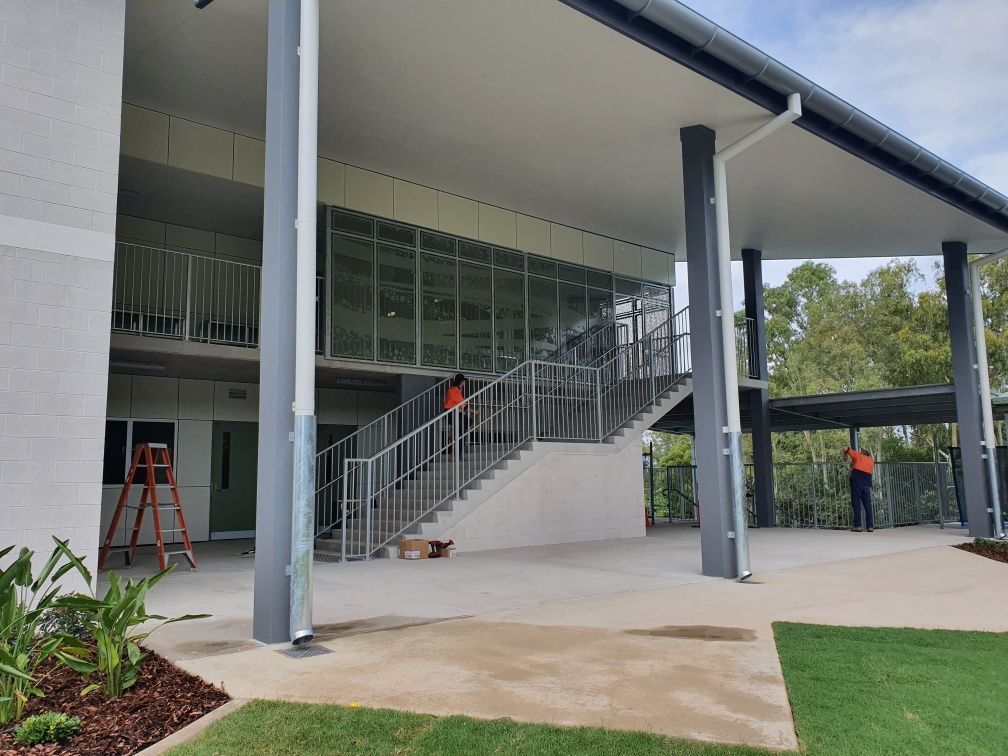 A large building with stairs leading up to the second floor.