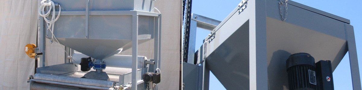 A large metal container is sitting next to a building.