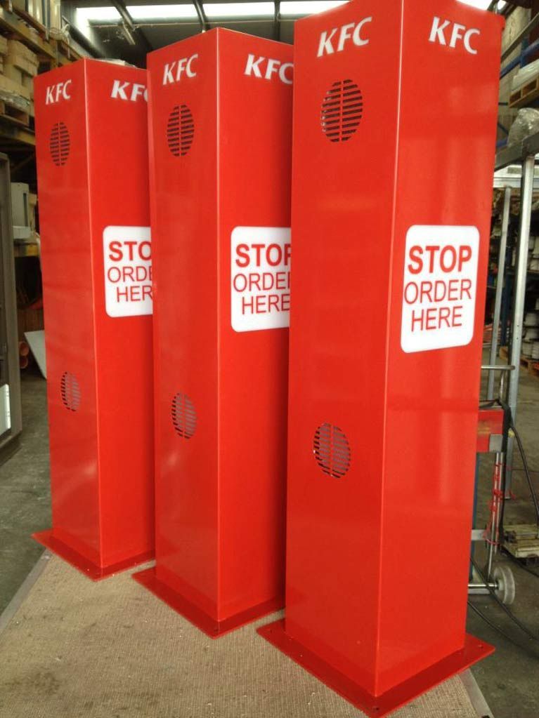 A row of red pillars that say stop order here