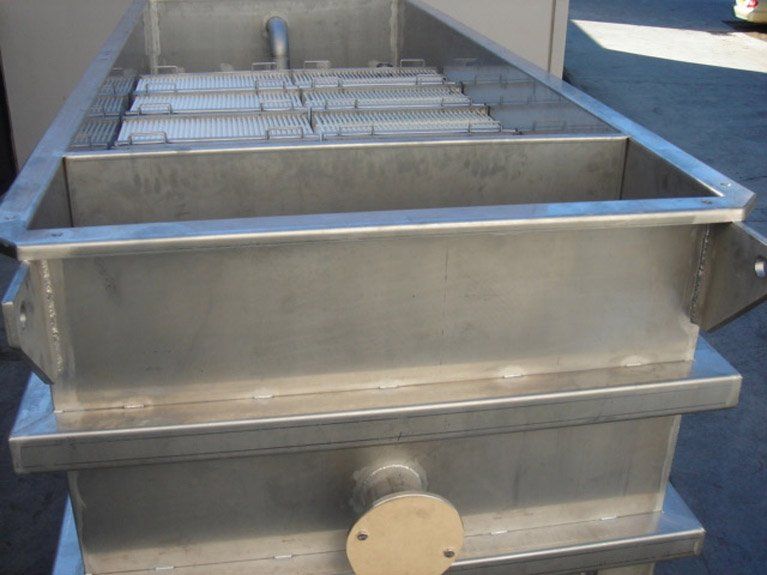 A large stainless steel container is sitting on the ground