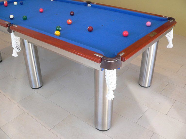A pool table with balls on it and a blue cloth