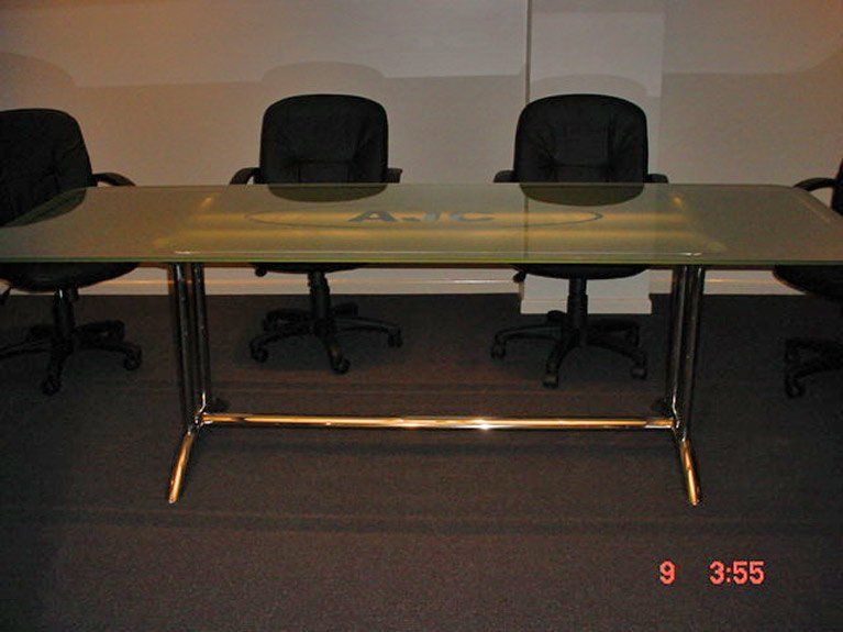 A meeting room with a glass table and chairs and the date 9 3:55
