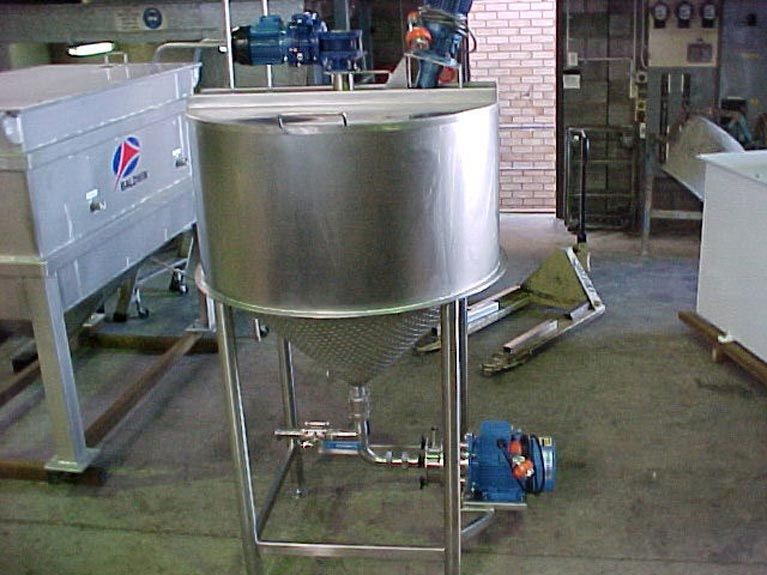 A large stainless steel tank is sitting on a stand in a room.