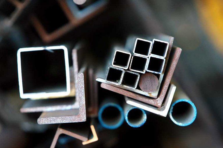 A bunch of metal pipes and squares are stacked on top of each other