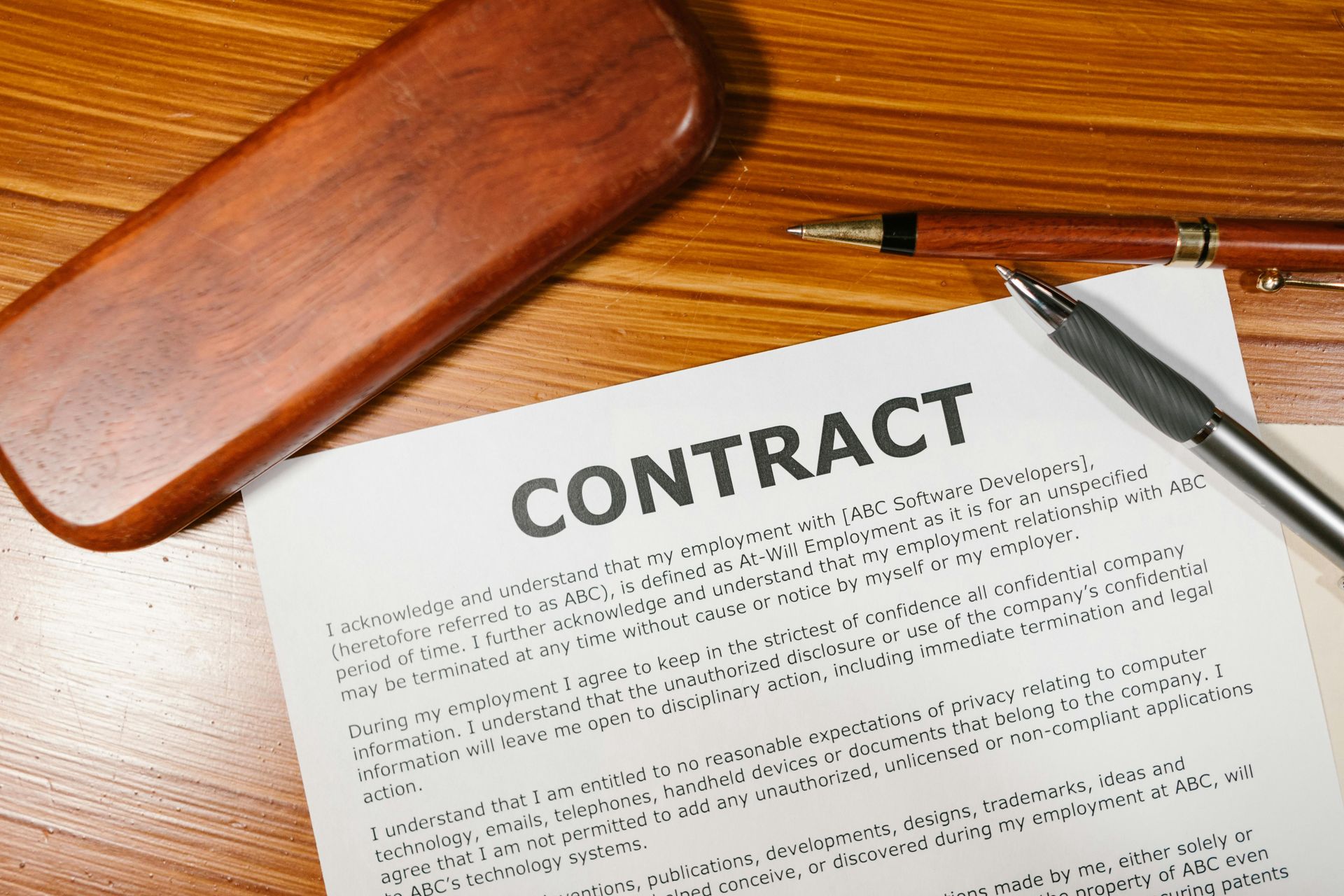 A piece of paper with the word contract written on it