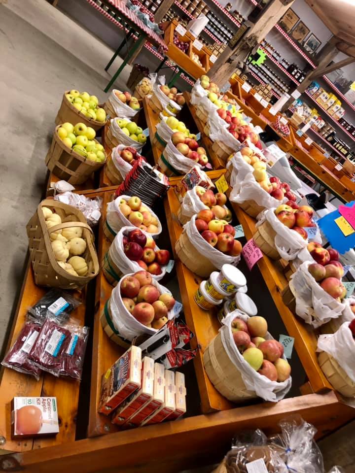 A bunch of baskets of apples are on display in a store.
