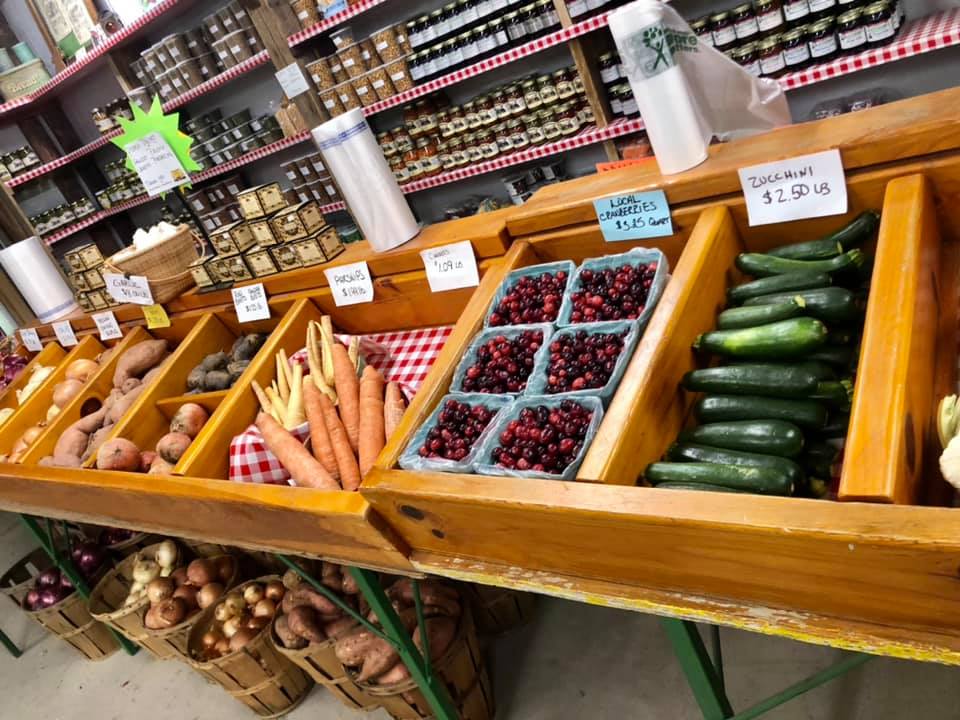 A variety of fruits and vegetables are on display in a grocery store.