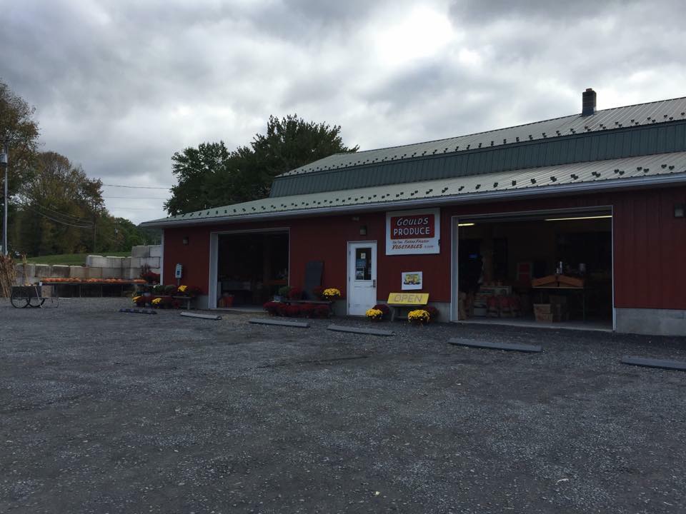 A red building with a green roof and a white door