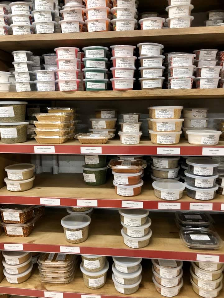 A store shelf filled with lots of containers of food.