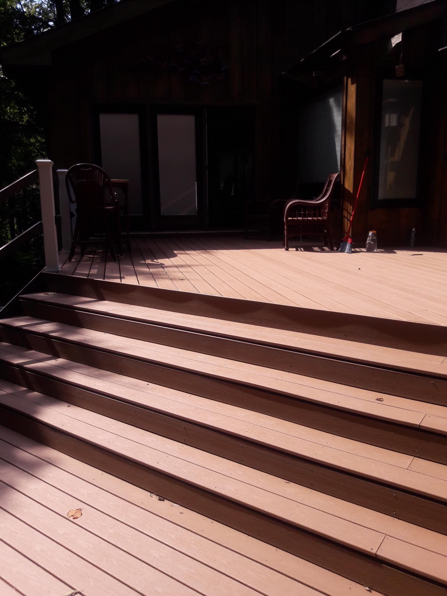 A wooden deck with stairs leading up to it