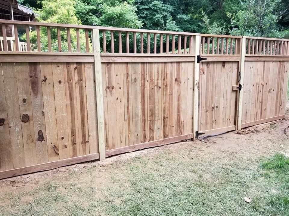 A wooden fence with a gate in the backyard