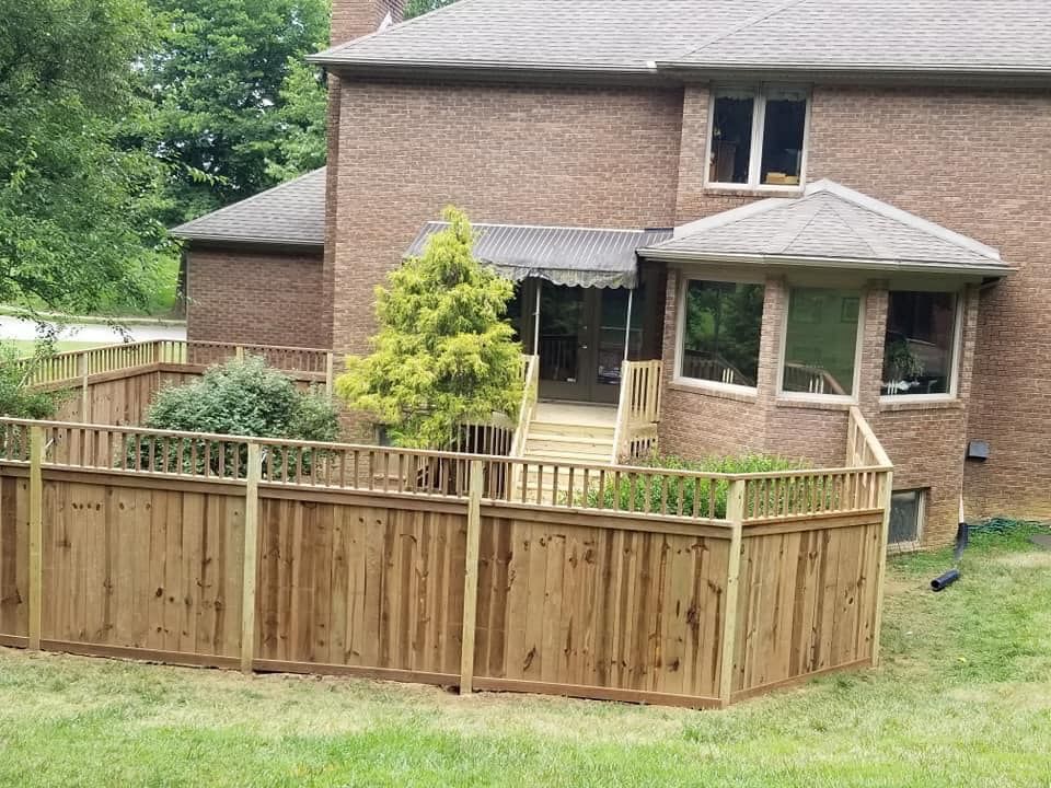 A brick house with a wooden fence in front of it