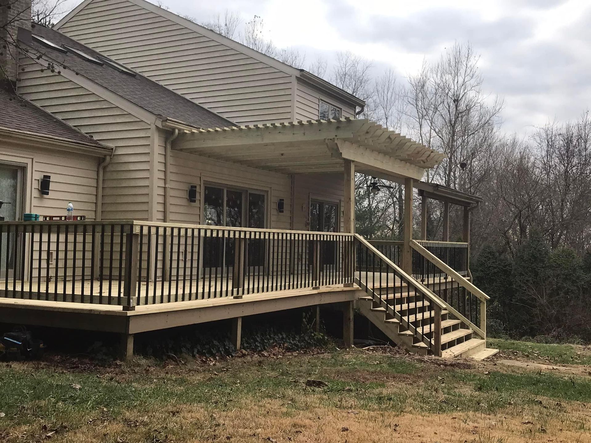 A house with a large deck and stairs in front of it.