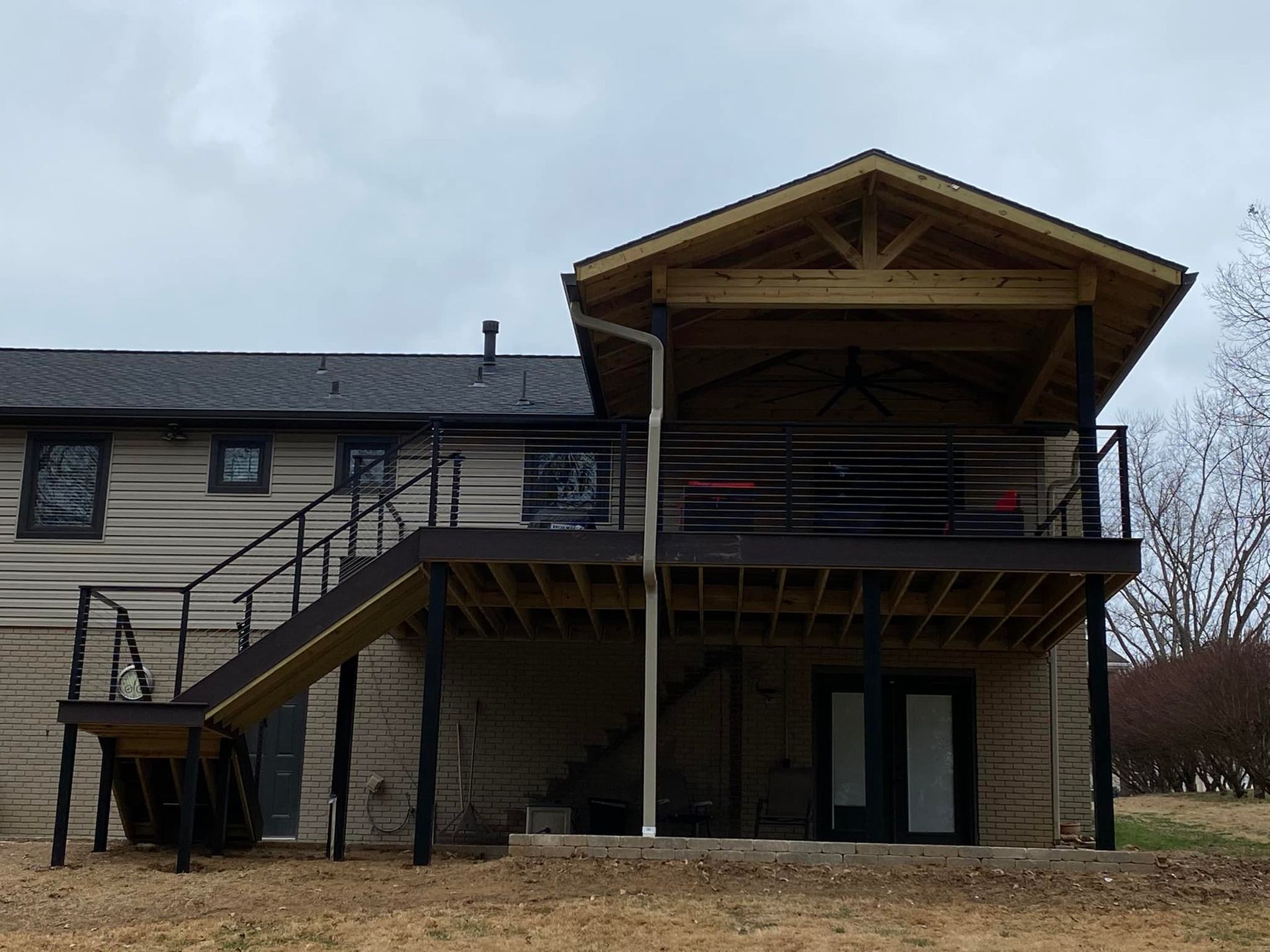 The back of a house with a deck and stairs.