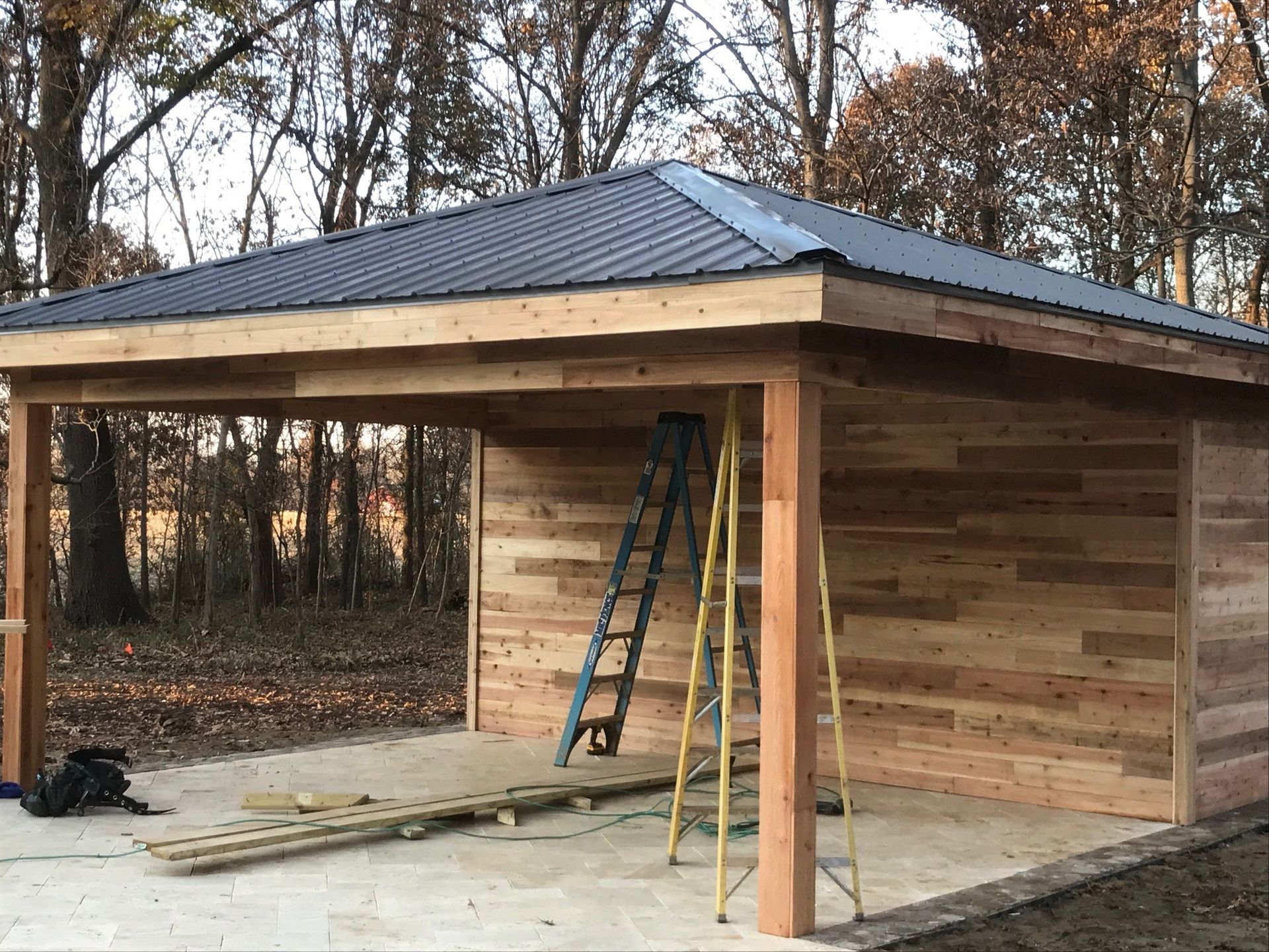 A wooden building with a metal roof is being built.