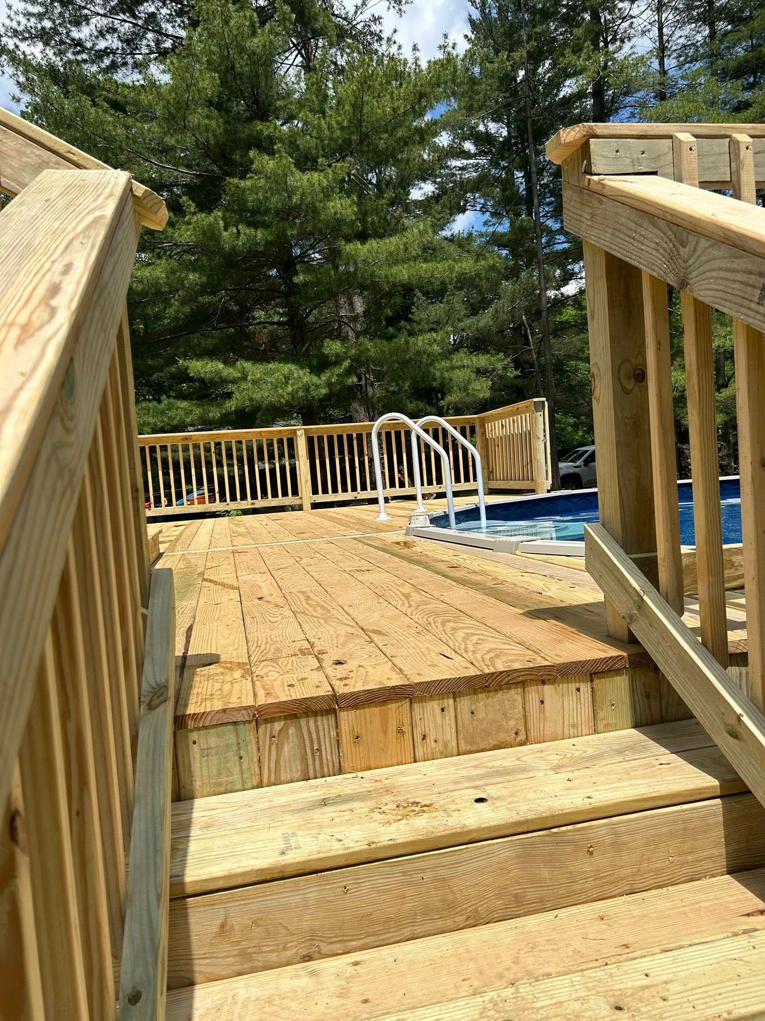 A wooden deck is being built next to a swimming pool.