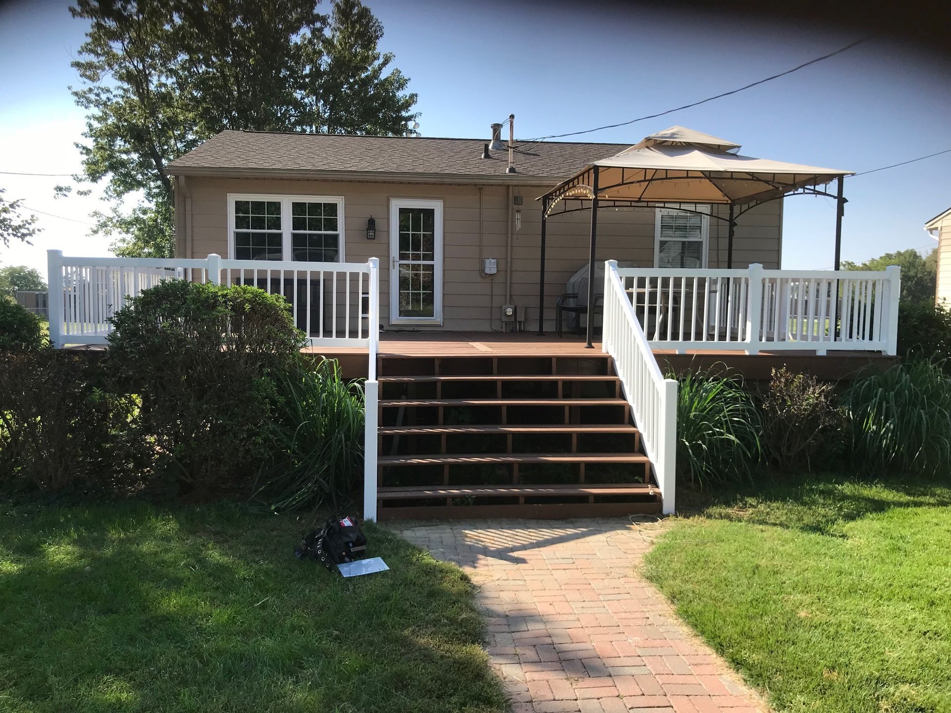A house with a large deck and stairs leading to it