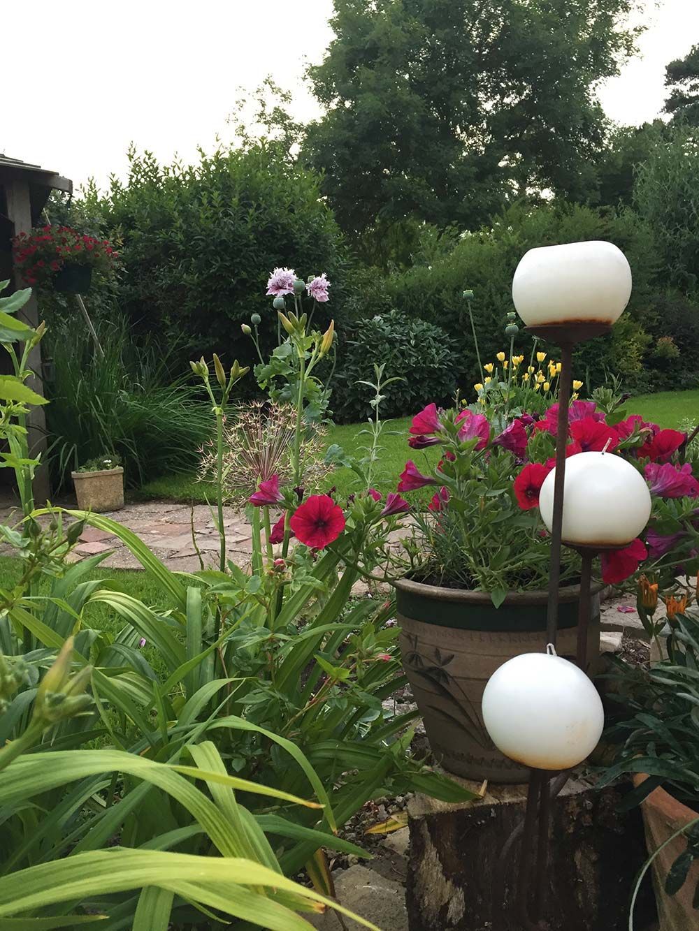 A garden with flowers and candles in a pot