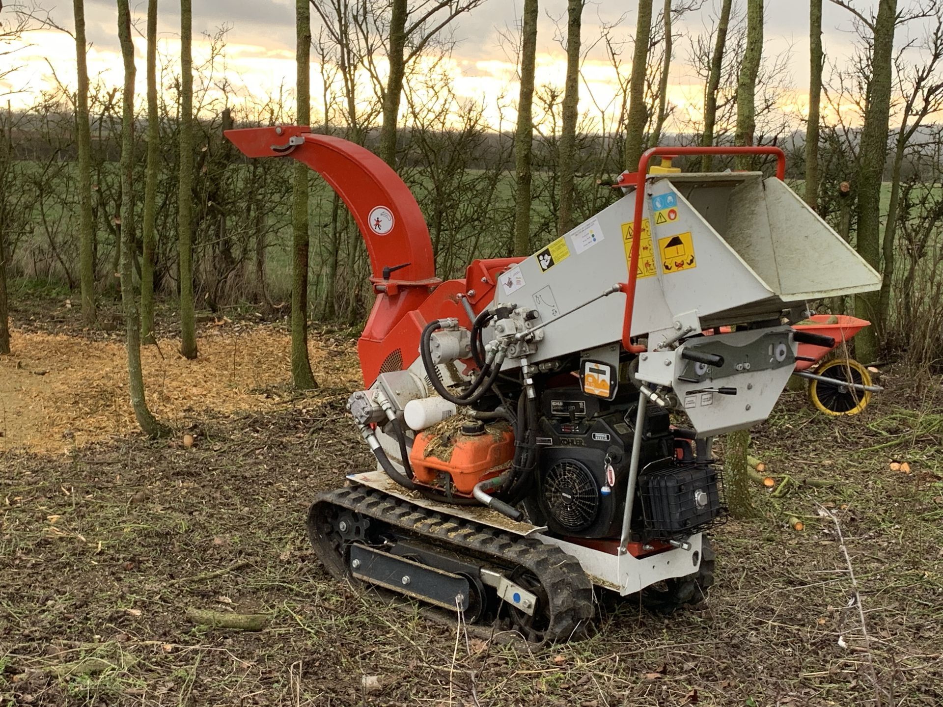 A small machine is sitting in the middle of a forest.