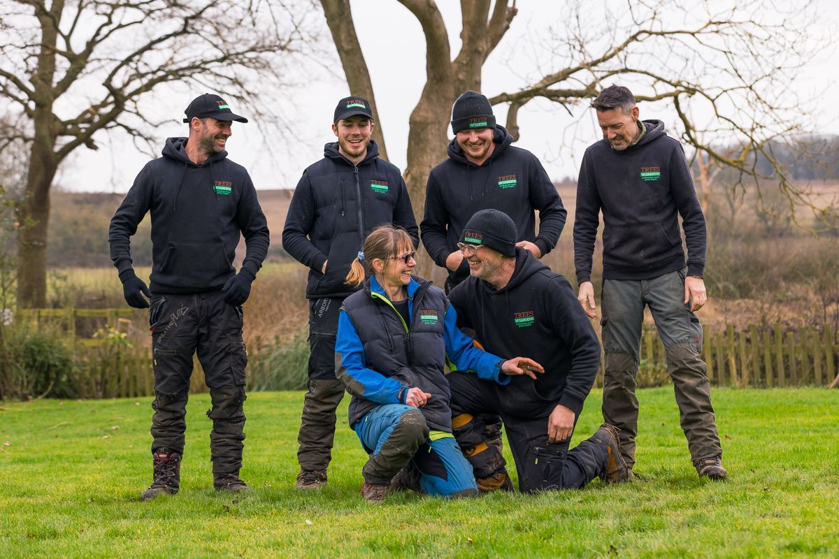 A group of men are posing for a picture in a field.