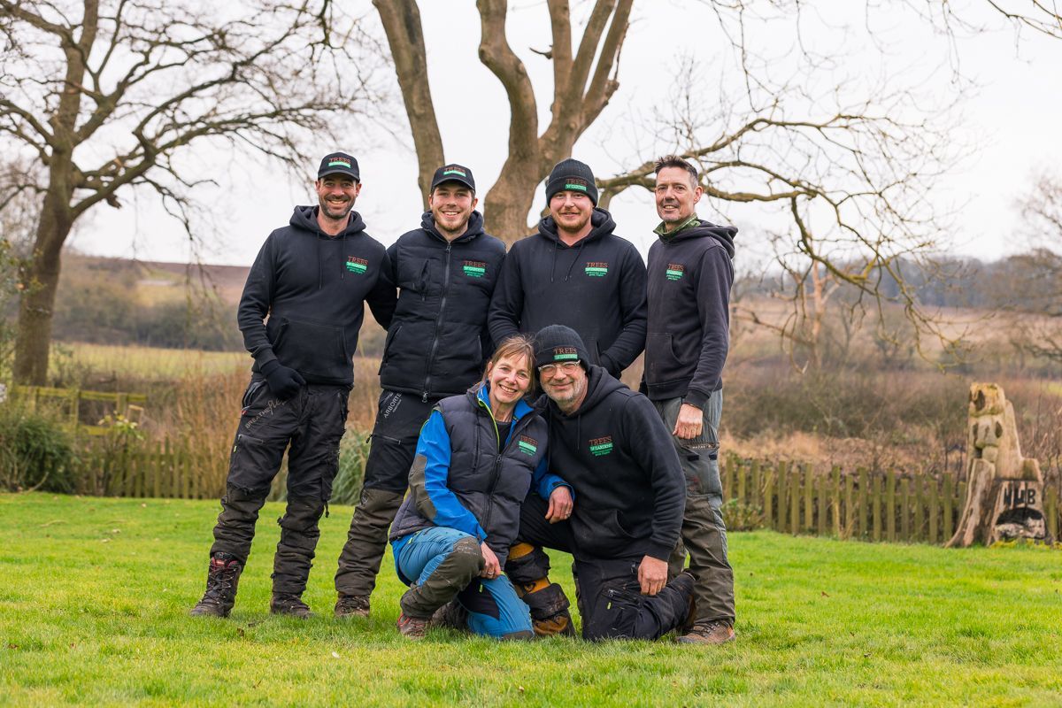 A group of people are posing for a picture in a field.