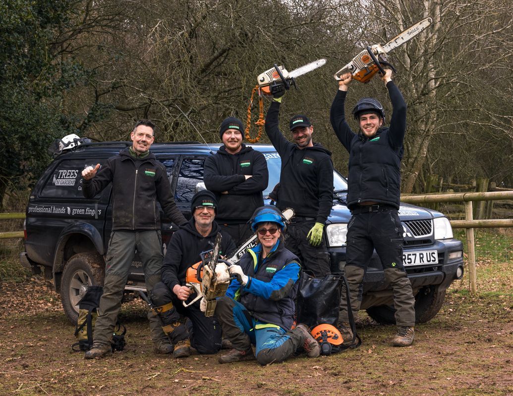 A group of men are posing for a picture in front of a truck.