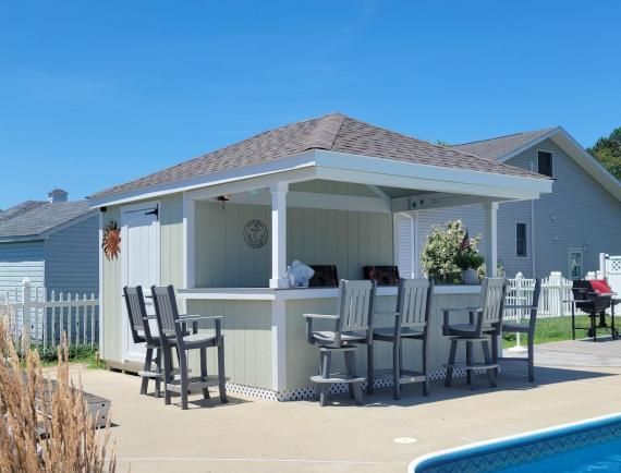 rip roof cabana with tan siding and a bar area with pub chairs