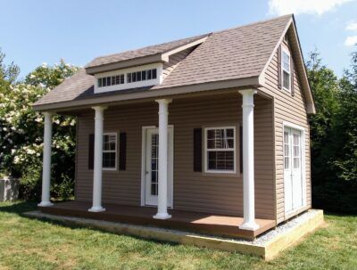 dormer shed with an siding, with a front porch and white columns