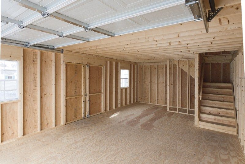interior of a two story detached garage with a staircase to the second floor