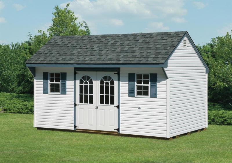 white quaker shed with blue trim and grey roof