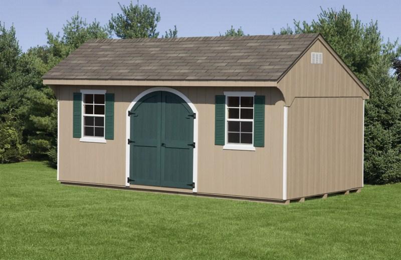 Quaker Shed with tan wood siding, white trim, a set of dark green curved double doors, 2 white windows with dark green shutters, and a brown asphalt roof.